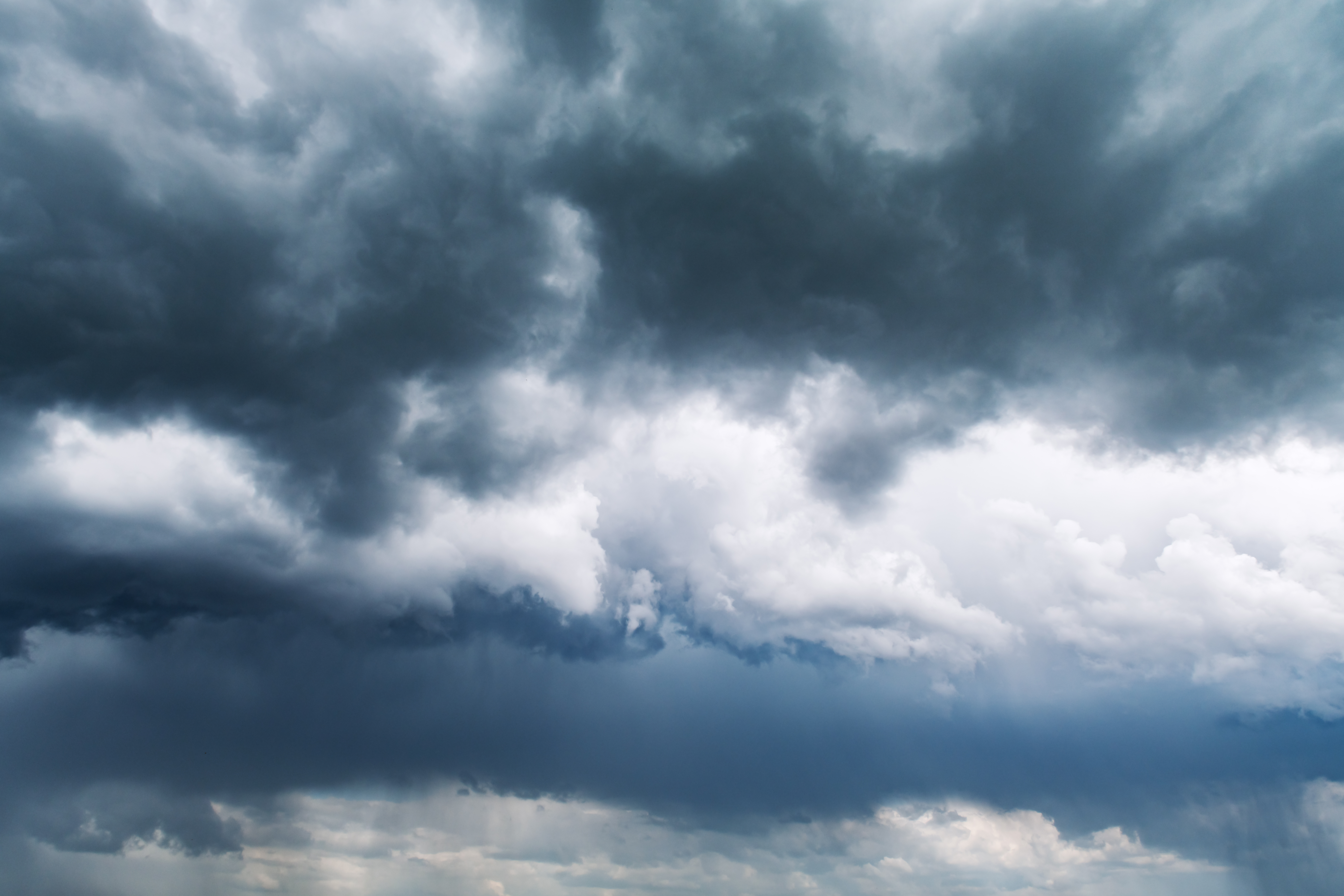 Ominous dark storm clouds gathering overhead in the sky