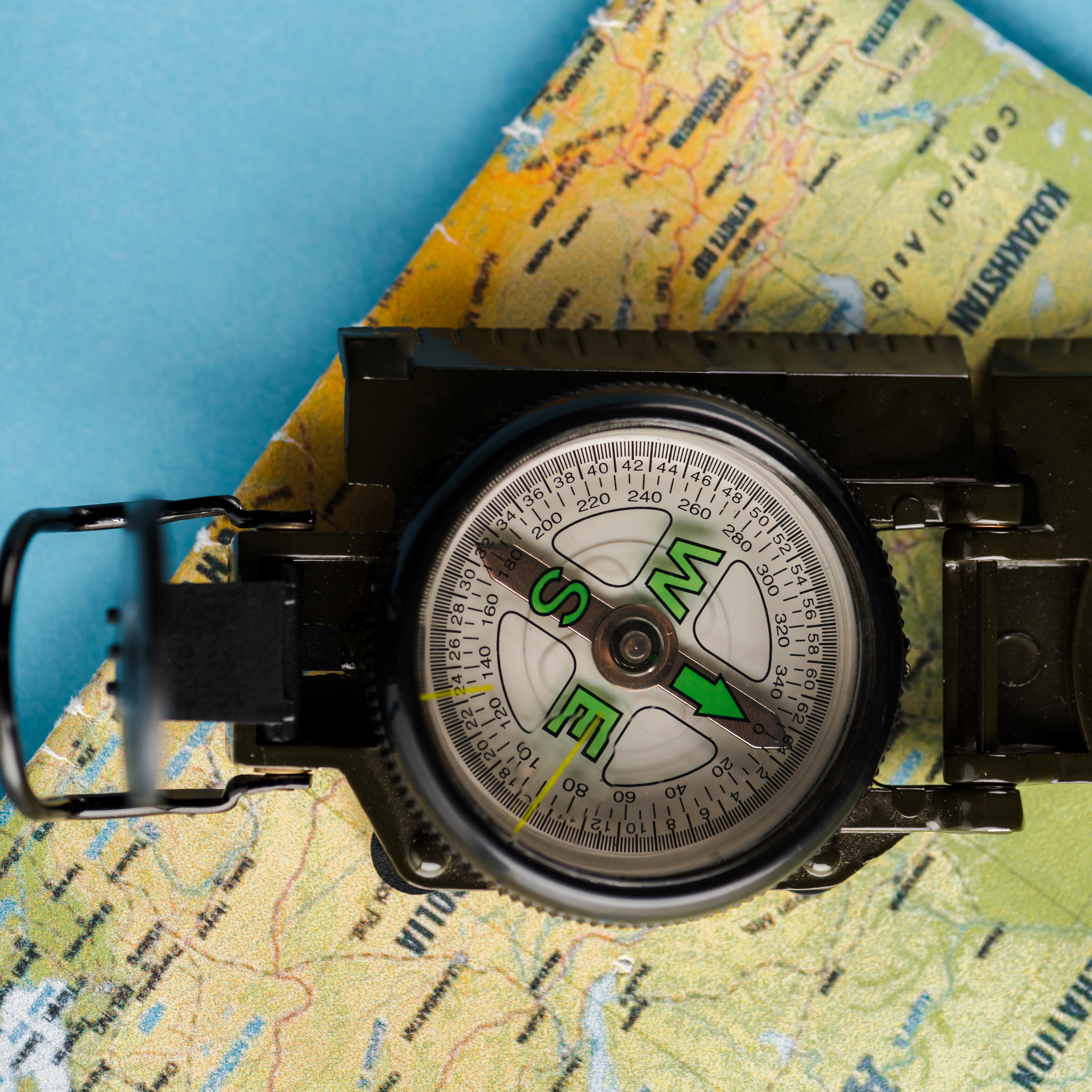 A compass resting on a map, symbolizing navigation and direction
