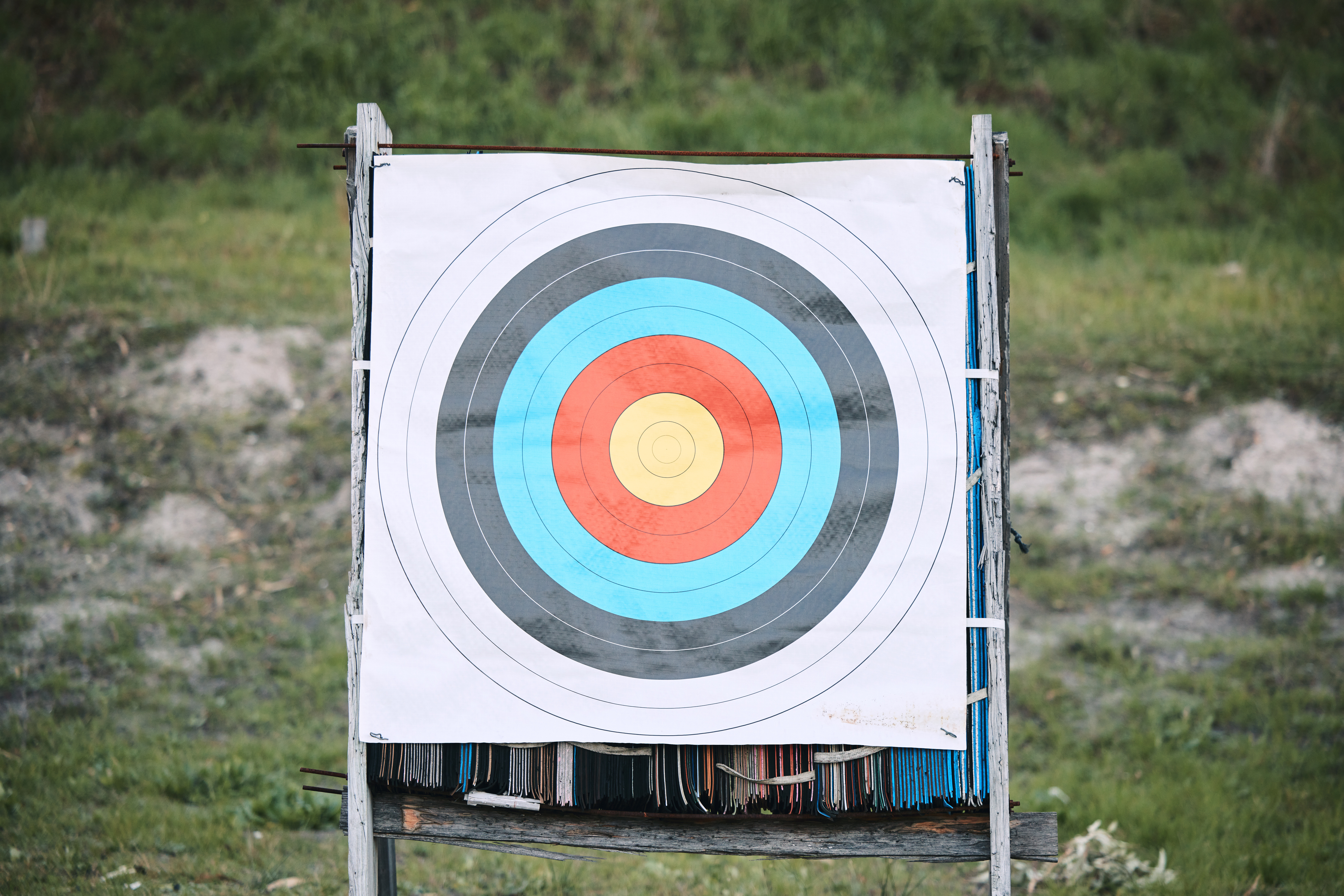 An archery target with concentric circles on an outdoor range